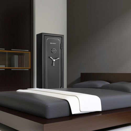 BASALT 14 fireproof gun safe, standing in a bedroom beside the bed and a bookshelf